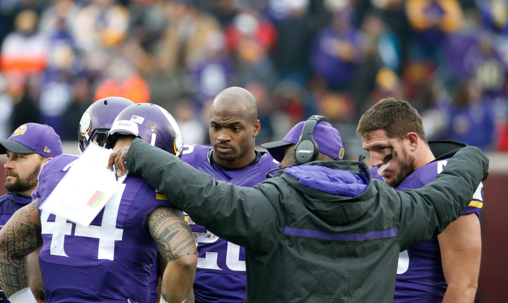 Minnesota Vikings running back Adrian Peterson (28) huddles with teammates on the field during the second half of an NFL football game against the Chicago Bears, Sunday, Dec. 20, 2015, in Minneapolis. (AP Photo/Ann Heisenfelt)