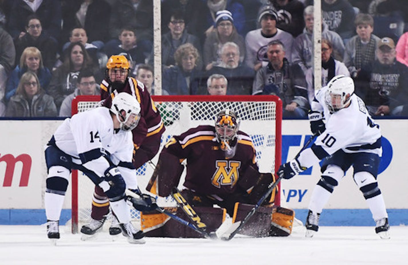 Minnesota's goaltender Eric Schierhorn (center) stops a shot by Penn State's Brandon Biro (10). Penn State's Nate Sucese waits for a rebound during Saturday's Big Ten Quarterfinals Game 2 at Univesity Park, Pa.  Penn State defeated Minnesota, 6-5. (Photo by Steve Manuel)