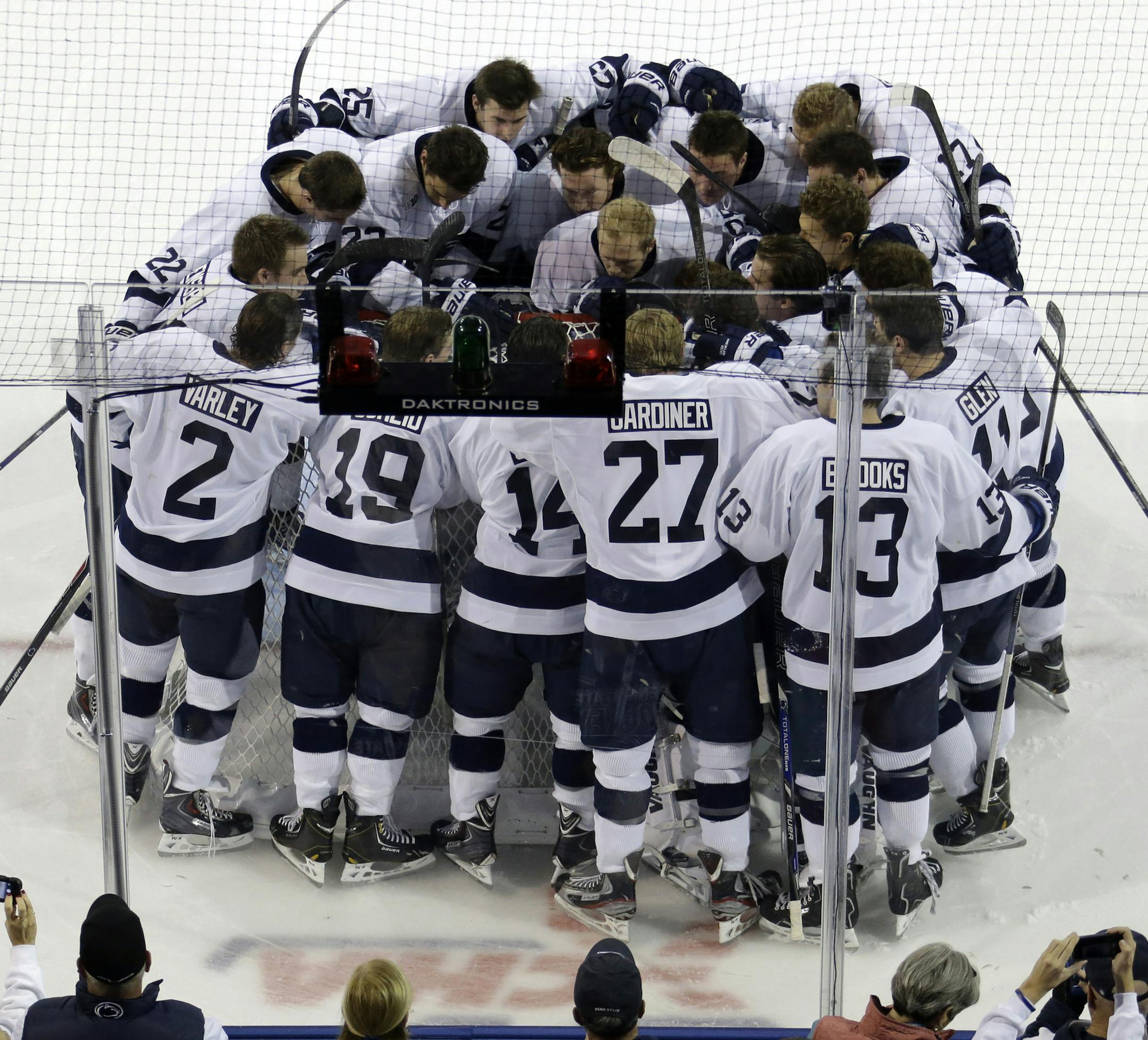 The Penn State men's hockey team gathers around goalie Matthew Skoff before facing off against Army in the first college hockey game at the new Pegula Ice Arena in State College, Pa., Friday, Oct. 11, 2013. (AP Photo/Gene J. Puskar)