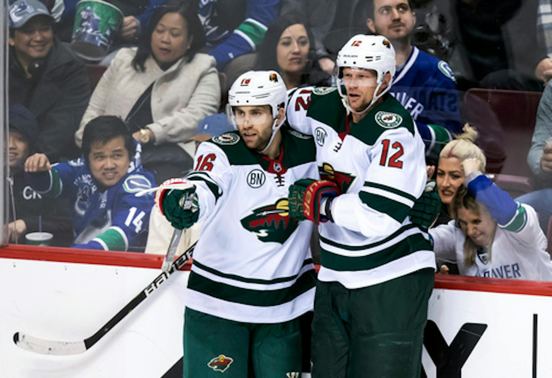 Minnesota Wild's Jason Zucker, left, and Eric Staal celebrate Zucker's second goal against the Vancouver Canucks during the second period of an NHL hockey game, Tuesday, Dec. 4, 2018, in Vancouver, British Columbia
