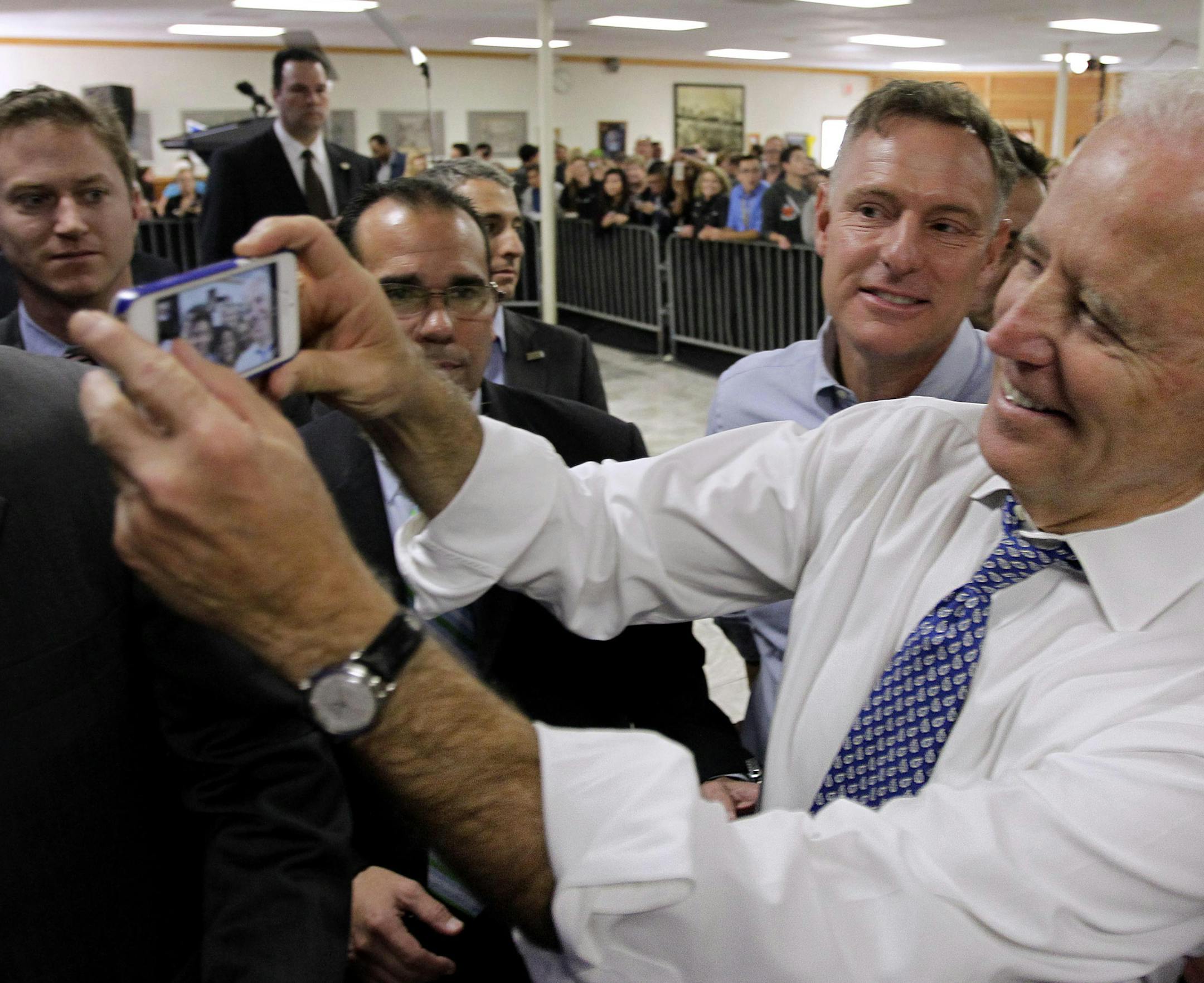 Vice President Joe Biden and Rep. Scott Peters, D-Calif., take a selfie at a campaign rally in San Diego at the International Association of Machinists and Aerospace Workers hall. Peters and opponent, Republican Carl Carl DeMaio are locked in a dead heat going into Tuesday's election. (AP Photo/U-T San Diego, Howard Lipin, Pool) ORG XMIT: MIN2014110115304722