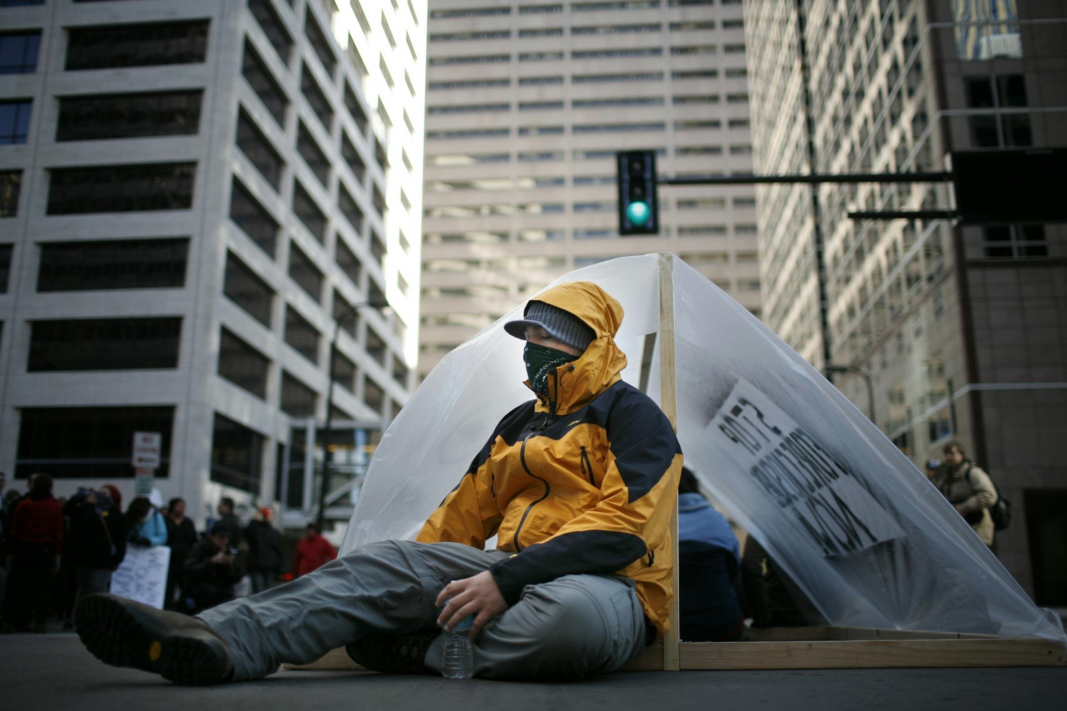Merritt Benton sits in the intersection at 6th St and 2nd Ave. Thursday as Occupy MN occupied the intersection. Benton continued to sit after the police asked everyone to clear the intersection. He was arrested.