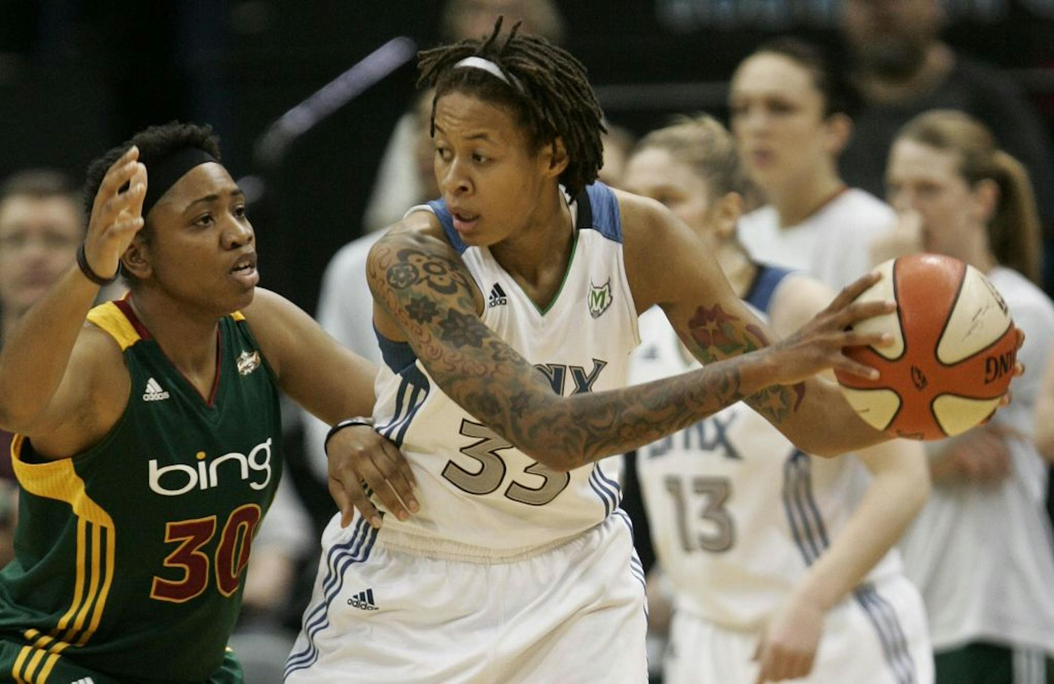 Lynx Seimone Augustus tried to find an open teammate with Seattle's Tanisha Wright defending in the first half at Target Center in Minneapolis , Minn., Friday, July 29, 2011.