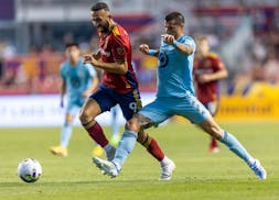 Real Salt Lake forward Justin Meram (9) tries to stay ahead of Minnesota United defender Alan Benitez (2) during an MLS soccer match Wednesday, Aug. 3