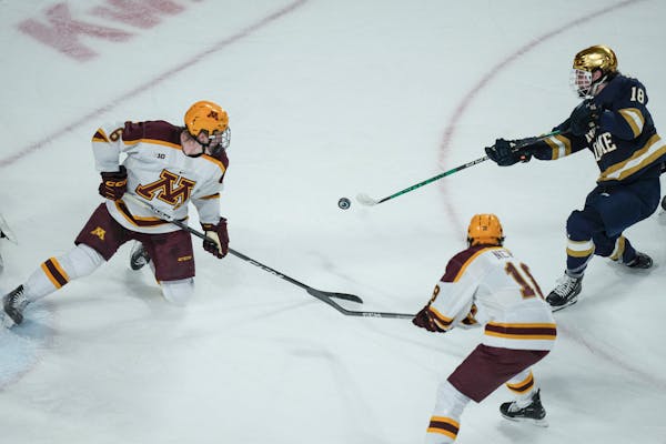 Notre Dame forward Patrick Moynihan (18) shoots on the Gophers' goal in the second period. The Minnesota Gopher's men's hockey hosted Notre Dame at 3M