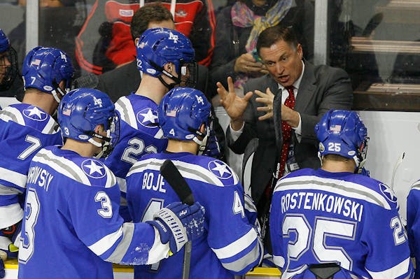 Air Force head coach Frank Serratore talks with his team during a time out during the first period of an NCAA regional men's college hockey tournament