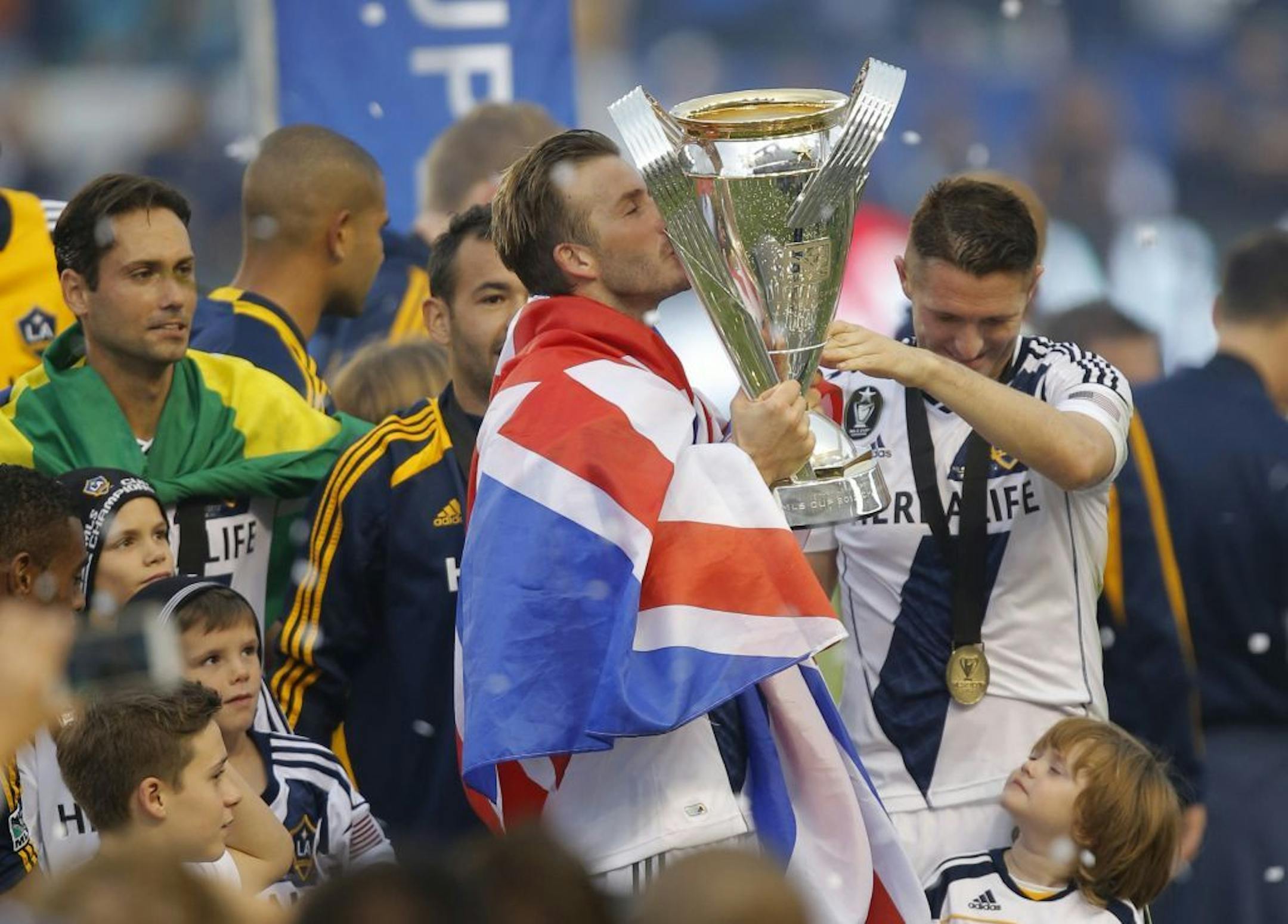 Los Angeles Galaxy's David Beckham kisses the trophy.