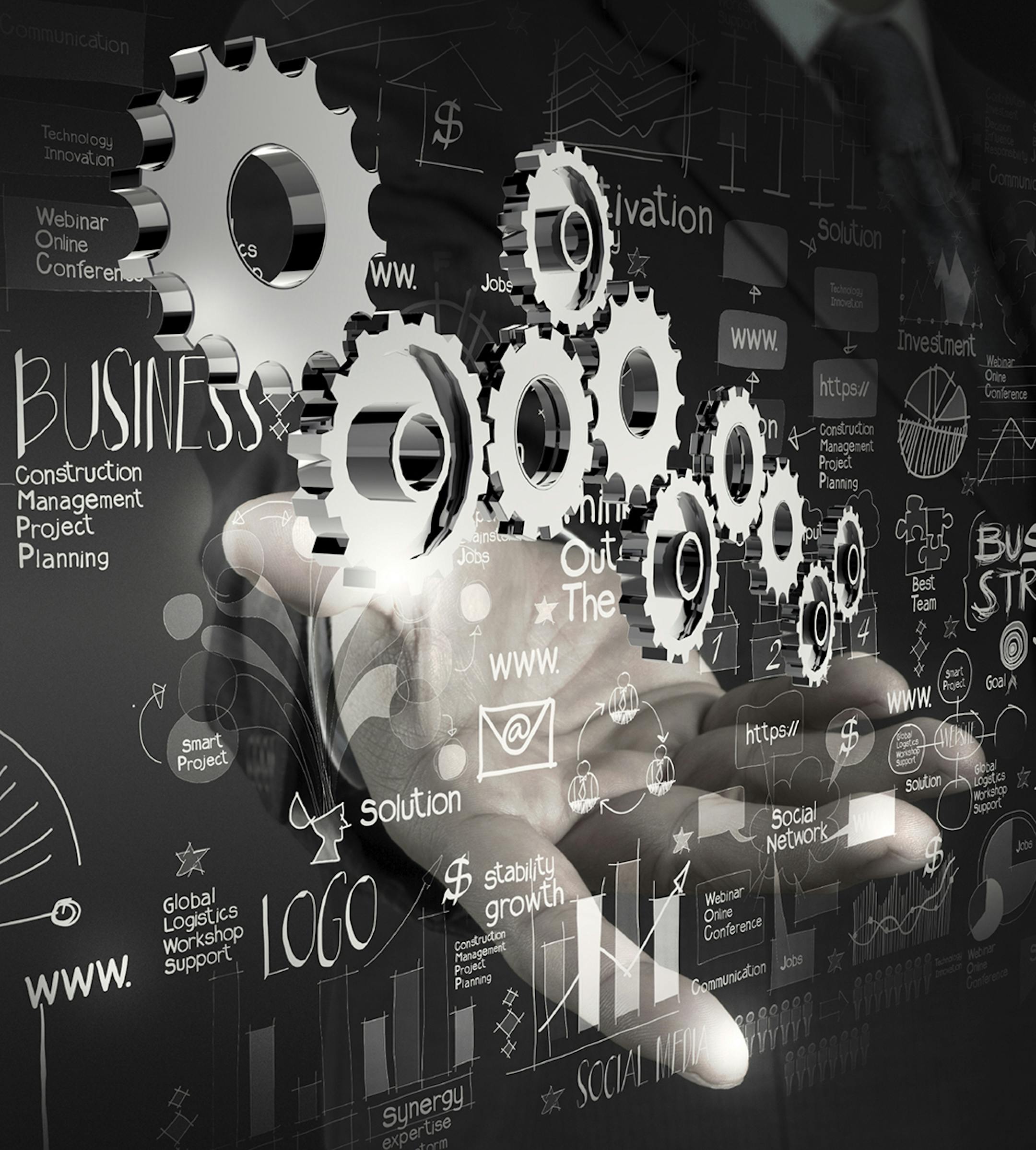 businessman hand working with new modern computer and business strategy gear to success as concept