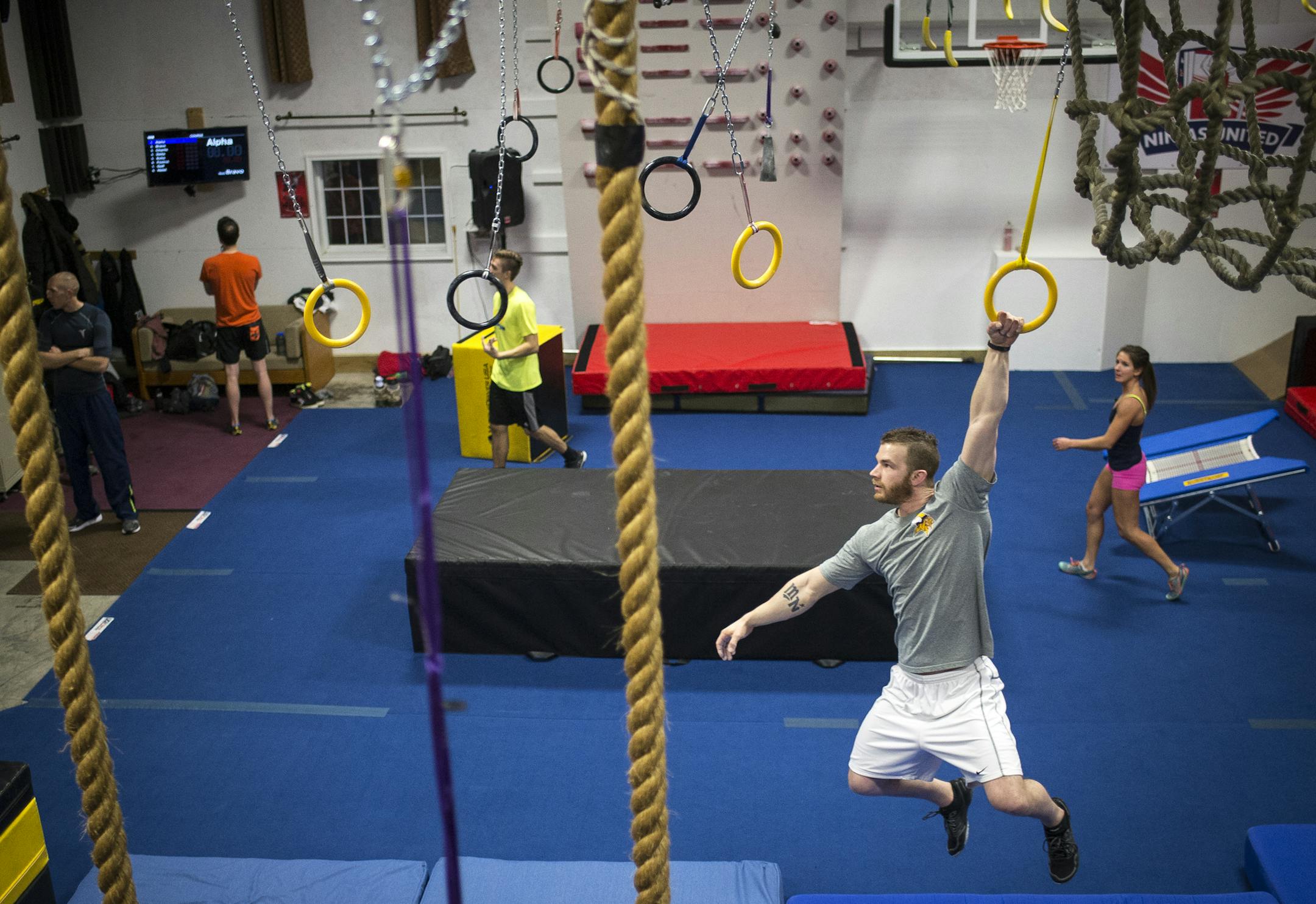 Dylan Mayasich, of Minneapolis, swung across an obstacle course at Ninjas United Thursday night. Mayasich makes the trek from Minneapolis 2-3 times a weekto Buffalo to work out. ] (AARON LAVINSKY/STAR TRIBUNE) aaron.lavinsky@startribune.com Profile on Jennifer Tavernier, a local fitness ninja who will appear as a contestant on a new spin-off to the popular American Ninja Warrior TV show. Tavernier trained for the obstacle-course competition at a Minnesota gym called Ninjas United - part of this