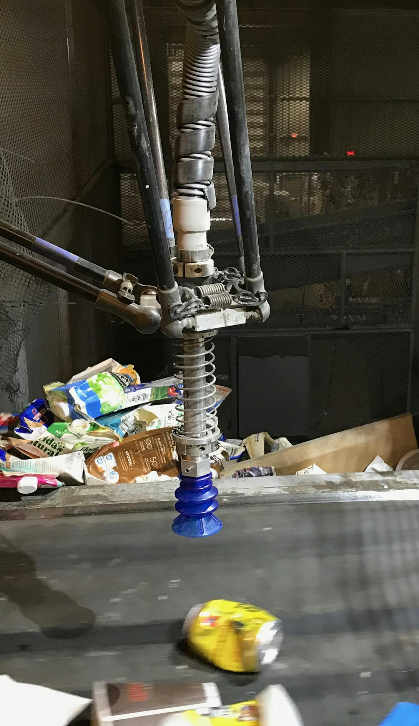 All manner of recyclable material moved beneath a robotic arm with a suction cup at the Dem-Con Companies' recycling facility in Shakopee.