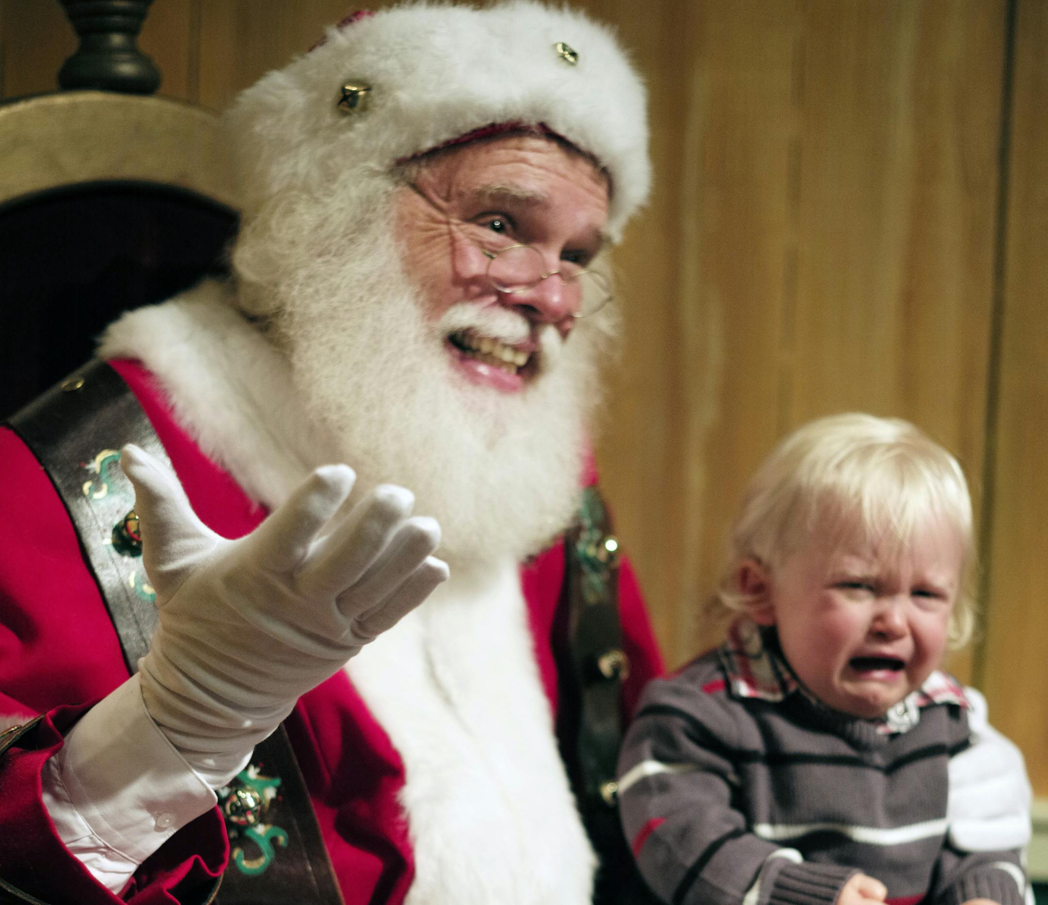 Santa Claus, aka Steve Graves, tried to get 18-month-old Landen Wilber of Cottage Grove to reveal his Christmas wish list, but the event was too much for Landen.