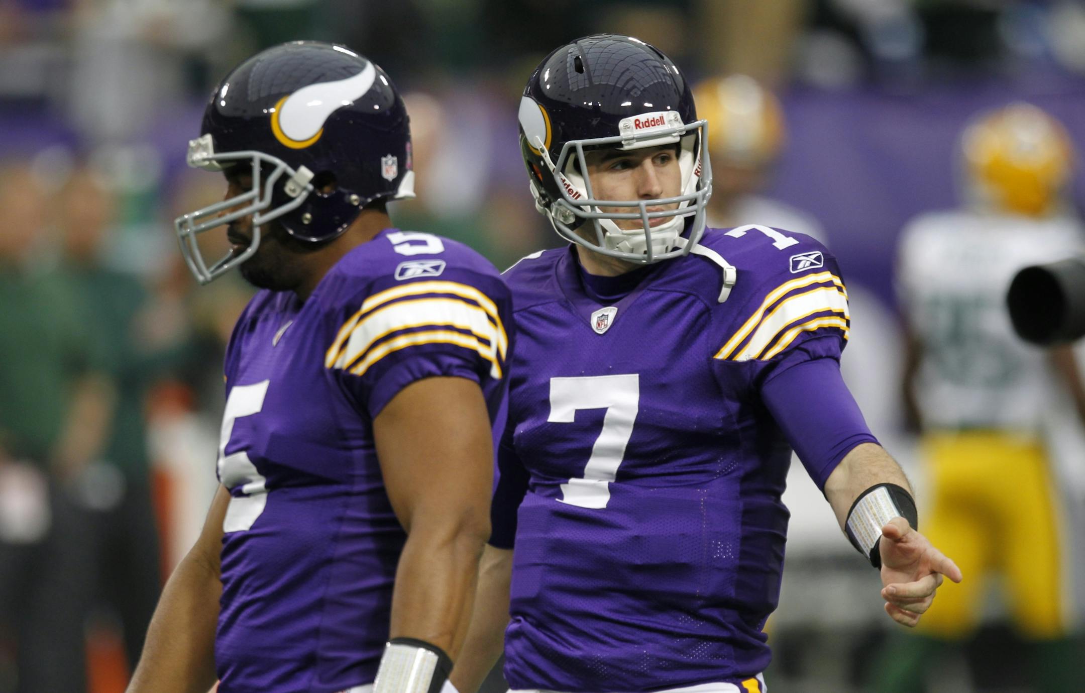 Minnesota Vikings quarterbacks Christian Ponder, right, and Donovan McNabb warmed up before the game against the Green Bay Packers.