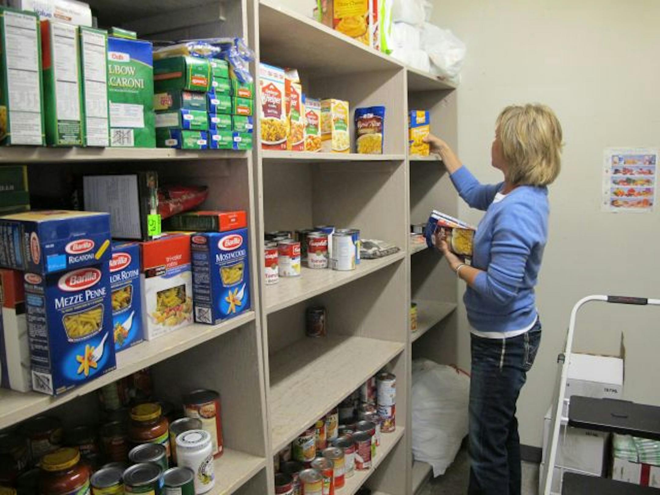 Volunteer Dianne Belski, 44, of Eagan, works in the food shelf area of the Rosemount Family Resource Center. The room will be remodeled by moving a wall to expand the space.