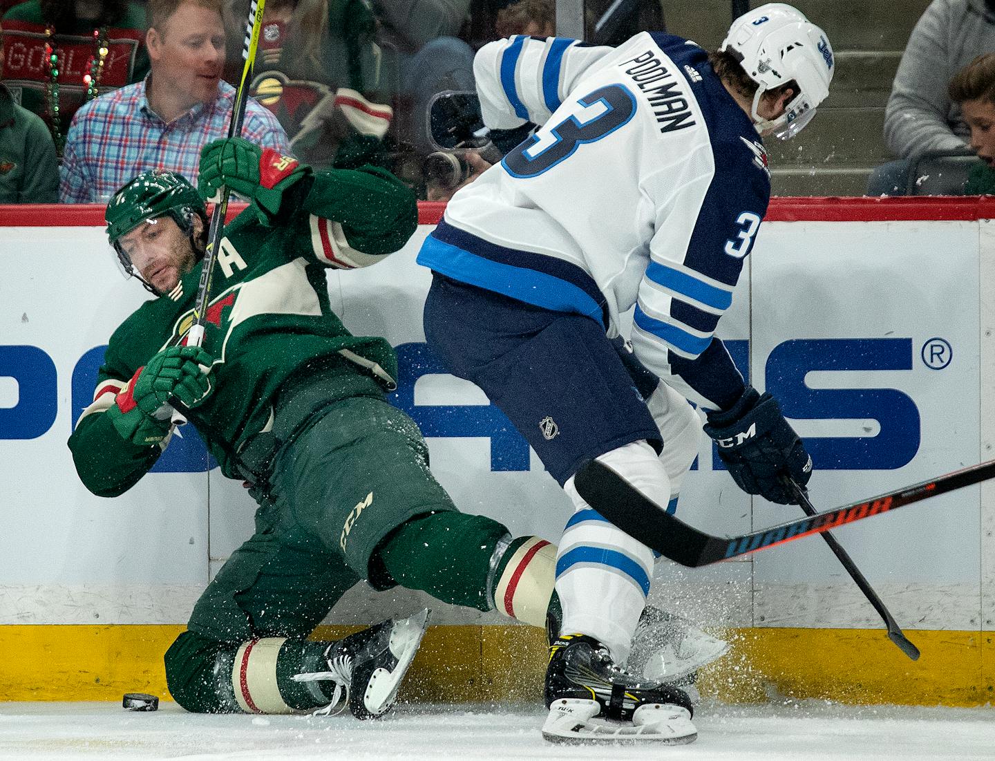 Matt Cullen (7) and Tucker Poolman (3) fought for the puck in the first period.