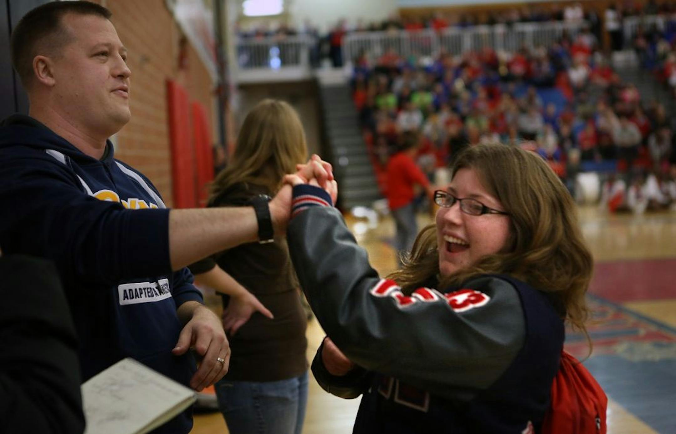 Senior Bailey Miller enjoyed celebrating with her coach, Marcus Onsum, during a pep rally at Robbinsdale Armstrong High School. Miller was a member of the school's state champion adapted soccer team, which was recognized for it's accomplishment at the rally.
