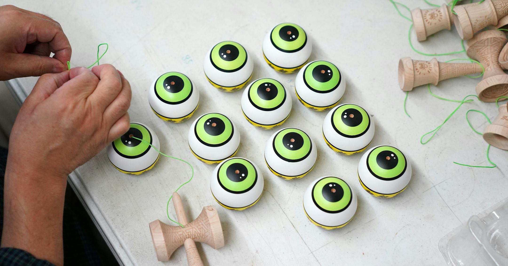 At top, Matt "Sweets" Jorgenson, the man largely responsible for bringing the kendama craze to the United States, has an extensive collection of the Japanese toy at the Sweets Kendamas office and warehouse in northeast Minneapolis. Above, assembly of kendamas.