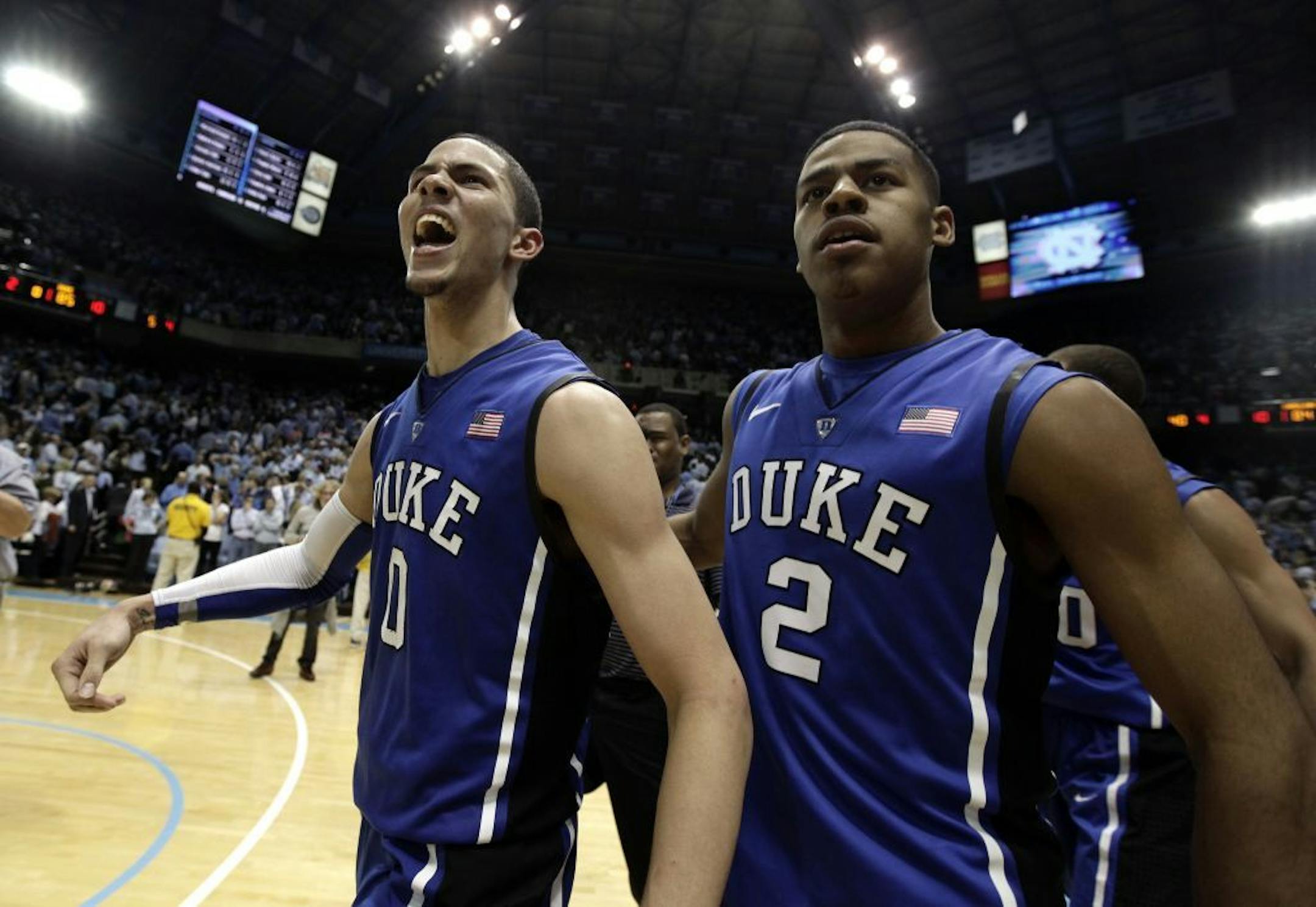 Duke's Austin Rivers (0) and Quinn Cook (2) celebrate Rivers' game-winning basket as time expired to defeat North Carolina in an NCAA college basketball game in Chapel Hill, N.C., Wednesday, Feb. 8, 2012. Duke won 85-84.