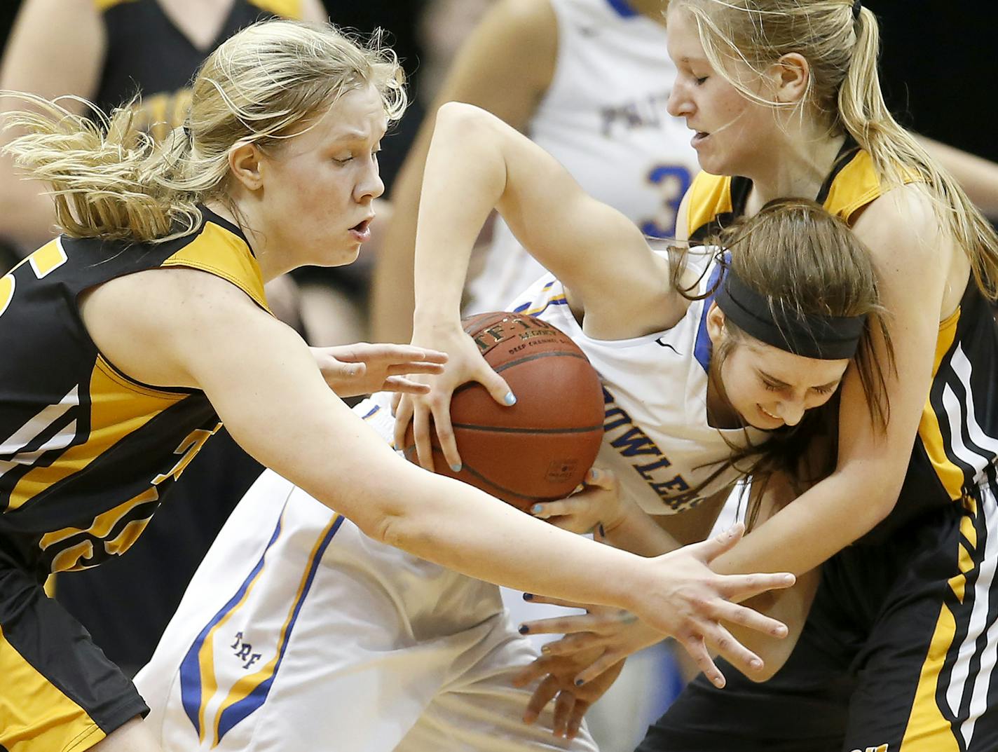 Kylea Praska (13) of Thief River Falls was defended by Erin Corrigan (15) and Morgan Kurth (4) of Hutchinson in the second half. ] CARLOS GONZALEZ cgonzalez@startribune.com - March 15, 2016, Minneapolis, MN, Target Center, Minnesota State High School / Prep Girl's Basketball state tournament quarterfinals Class 3A Hutchinson vs. Thief River Falls