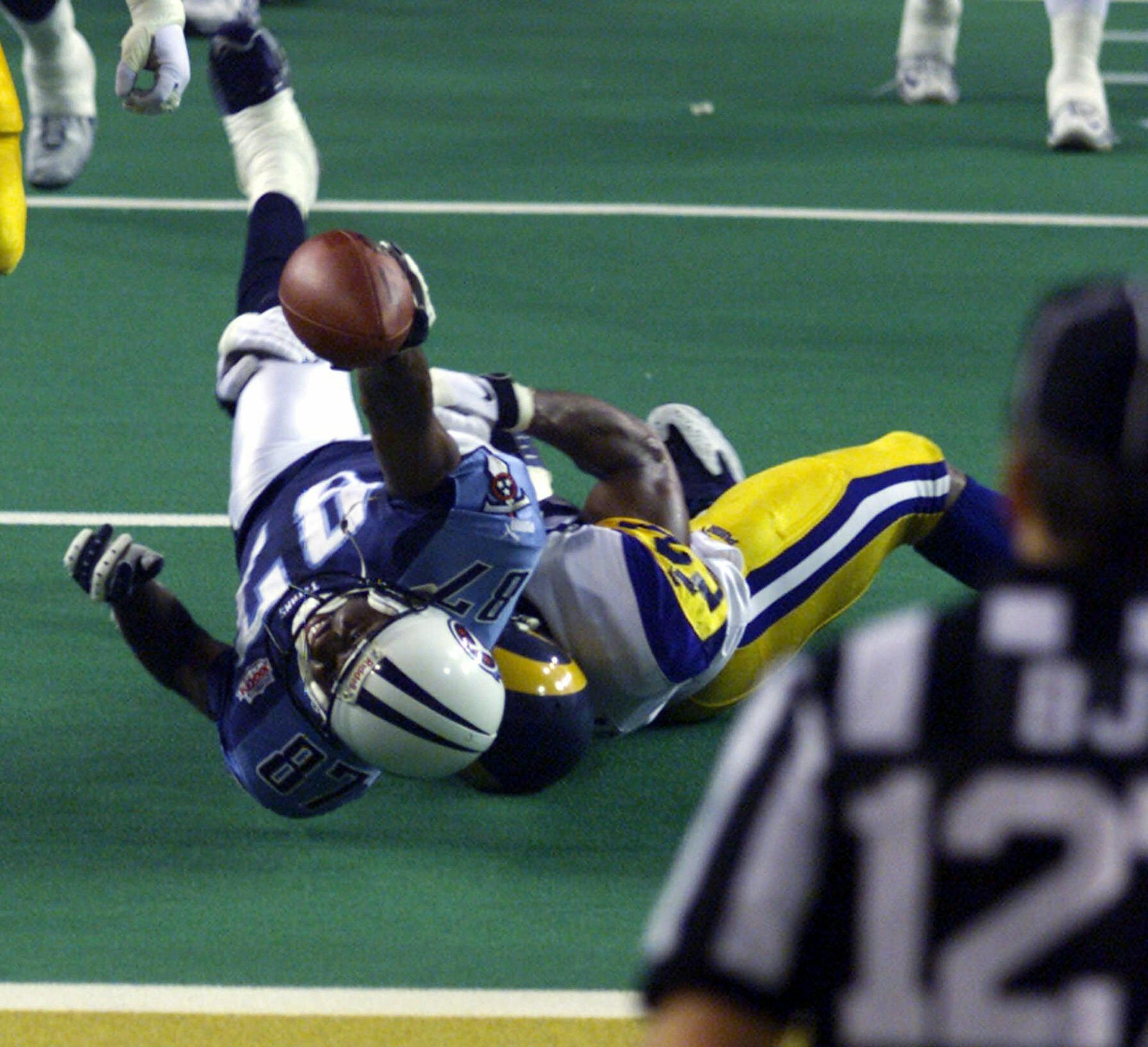 Tennessee Titans wide receiver Kevin Dyson (87) is tackled short of the goal line by St. Louis Rams linebacker Mike Jones on the final play of Super Bowl XXXIV to preserve the Rams 23-16 win Sunday, Jan. 30, 2000 in Atlanta. (AP Photo/Michael Conroy) ORG XMIT: ATG194