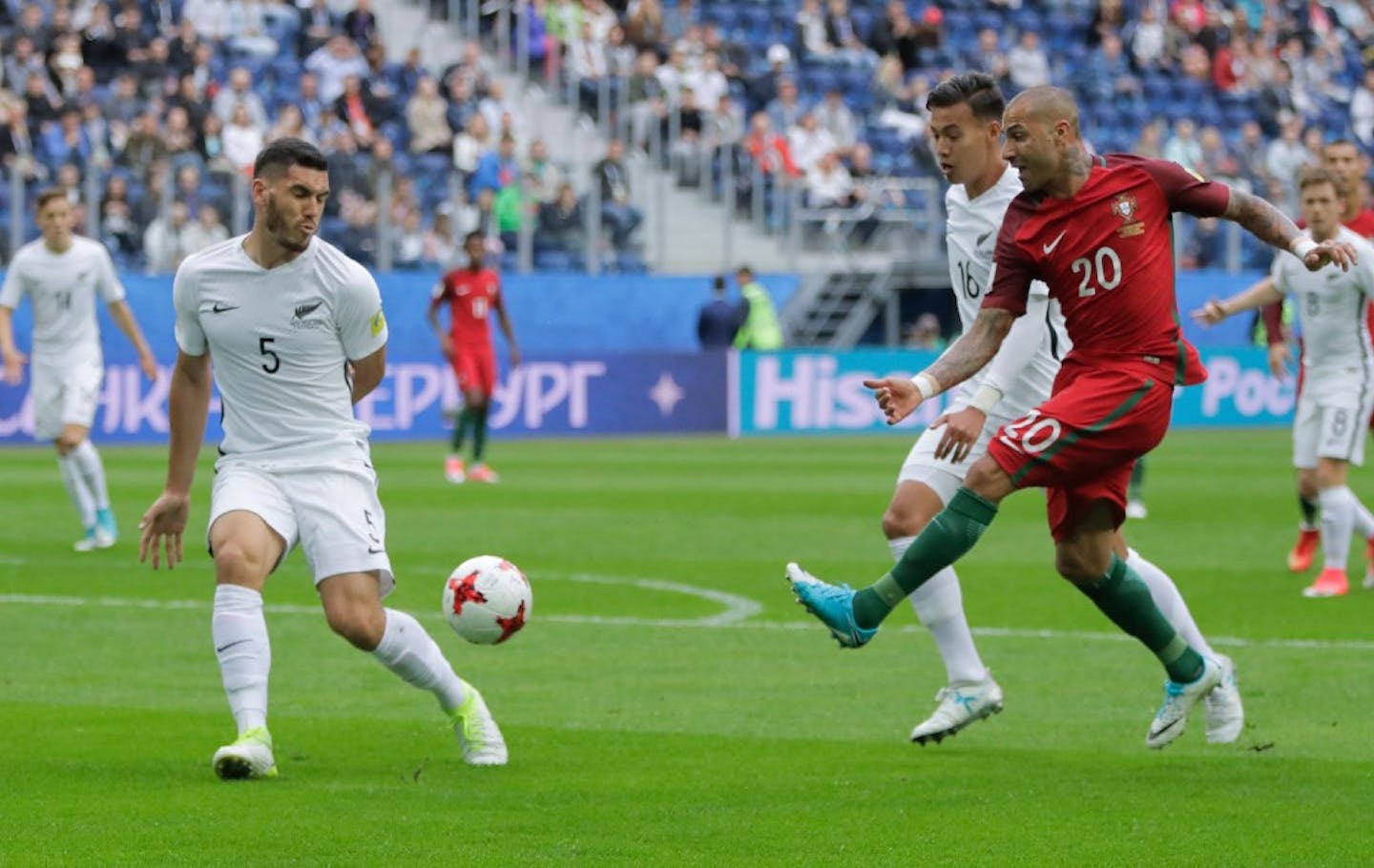 New Zealand's Michael Boxall, left, defends as Portugal's Ricardo Quaresma, right, kicks the ball past New Zealand's Dane Ingham during the Confederations Cup, Group A soccer match between New Zealand and Portugal, at the St. Petersburg Stadium, Russia, Saturday, June 24, 2017. (AP Photo/Pavel Golovkin)