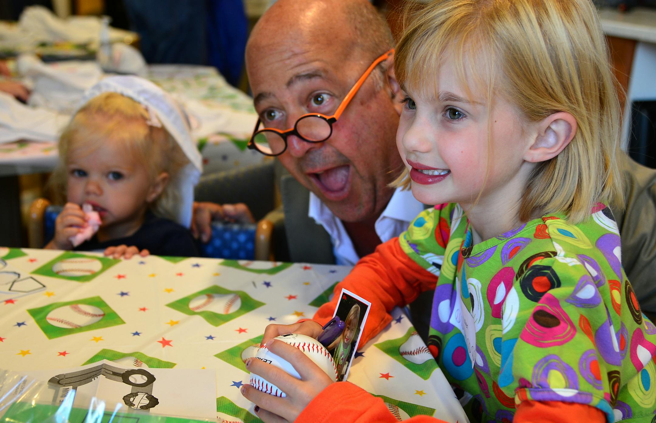 Andrew Zimmer, television personality, chef, food writer, and teacher, goofed for a picture with 2-year-old Maggie Muller of Edina and her 7-year-old sister Millie.