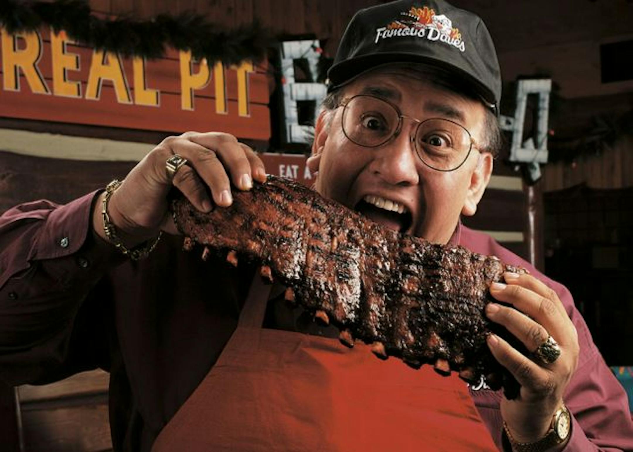 Famous Dave eating a rack of Famous Dave's ribs.