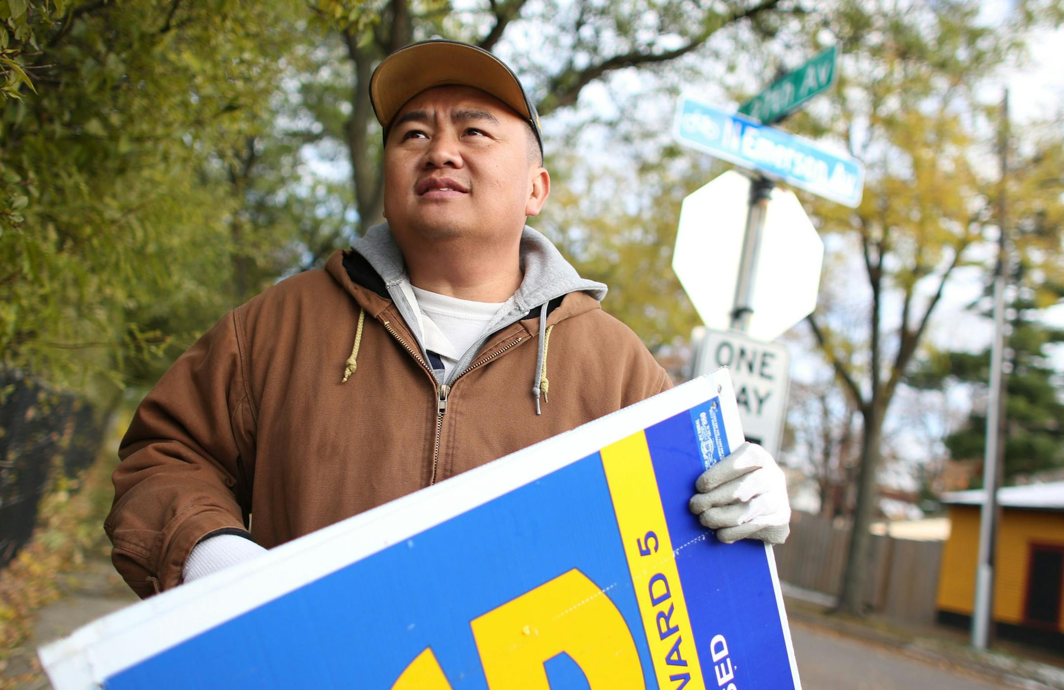 Blong Yang newly elected Minneapolis City Council member, prepared to pack up his lawn signs in the back of pick up truck in North Minneapolis, Min., Wednesday, November 6, 2013