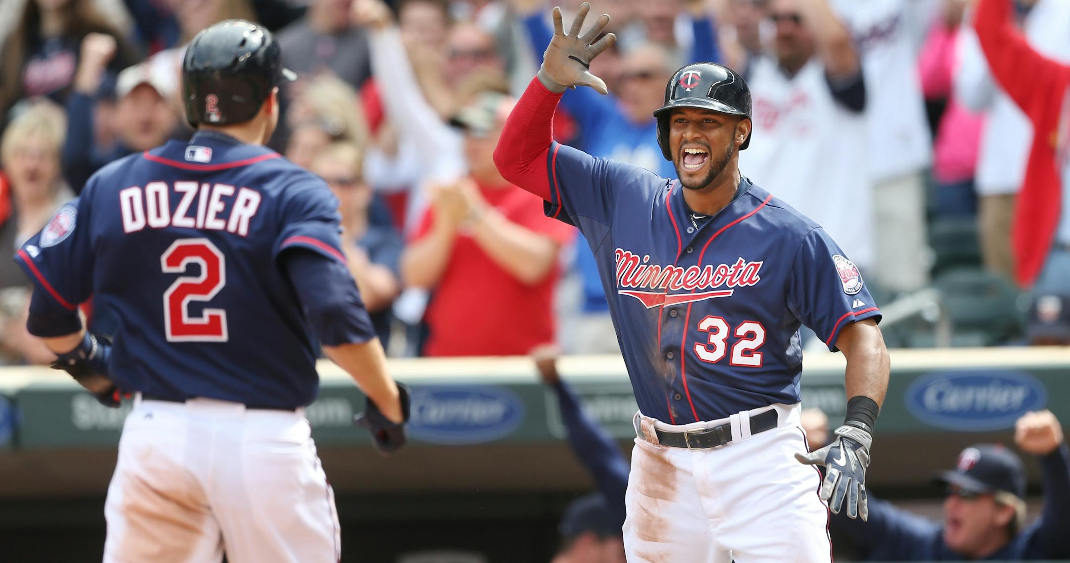 Brian Dozier, left, and Aaron Hicks celebrated after scoring on Torii Hunter's go-ahead double in the seventh inning of the Twins' 6-5 victory over Toronto on Sunday at Target Field.