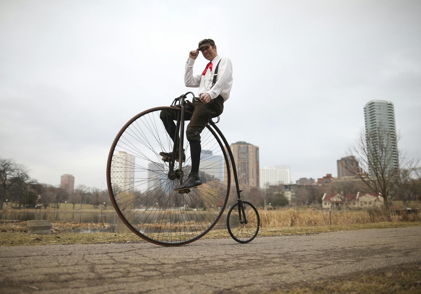 Antique bicycle collector Juston Anderson rides a high-wheeler in Loring Park. The style of bike is part of a new exhibit at the Hennepin History Museum.