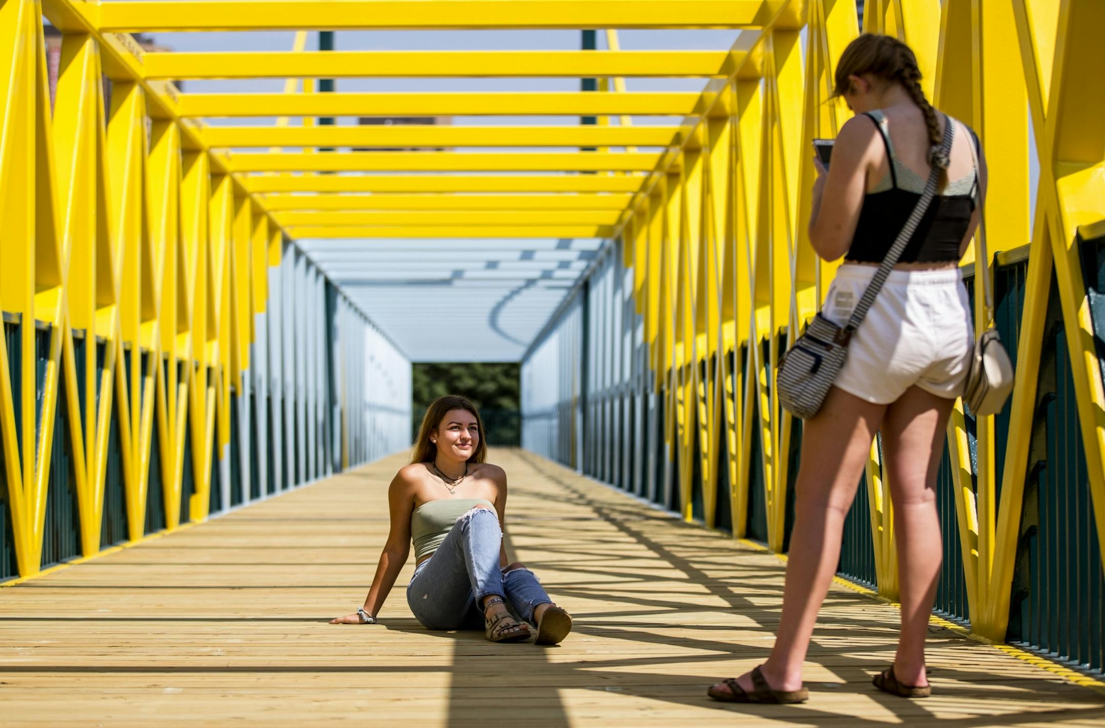 (Left) Marie Pfeilsticker and Kayla Lysne from Delano, MN spent part of their Friday afternoon takin pictures of each other on the bridge.