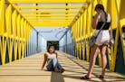 (Left) Marie Pfeilsticker and Kayla Lysne from Delano, MN spent part of their Friday afternoon takin pictures of each other on the bridge.