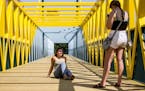 (Left) Marie Pfeilsticker and Kayla Lysne from Delano, MN spent part of their Friday afternoon takin pictures of each other on the bridge.