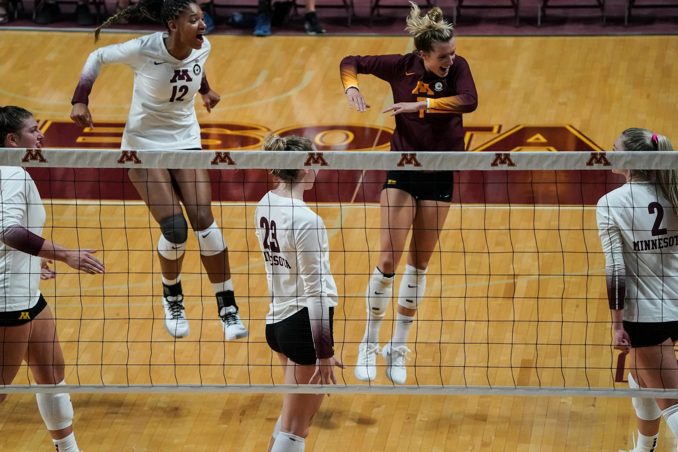 Minnesota Gophers teammates celebrated after Jenna Wenaas (2) scored a point in the fourth set. Texas defeated Minnesota 3-1.