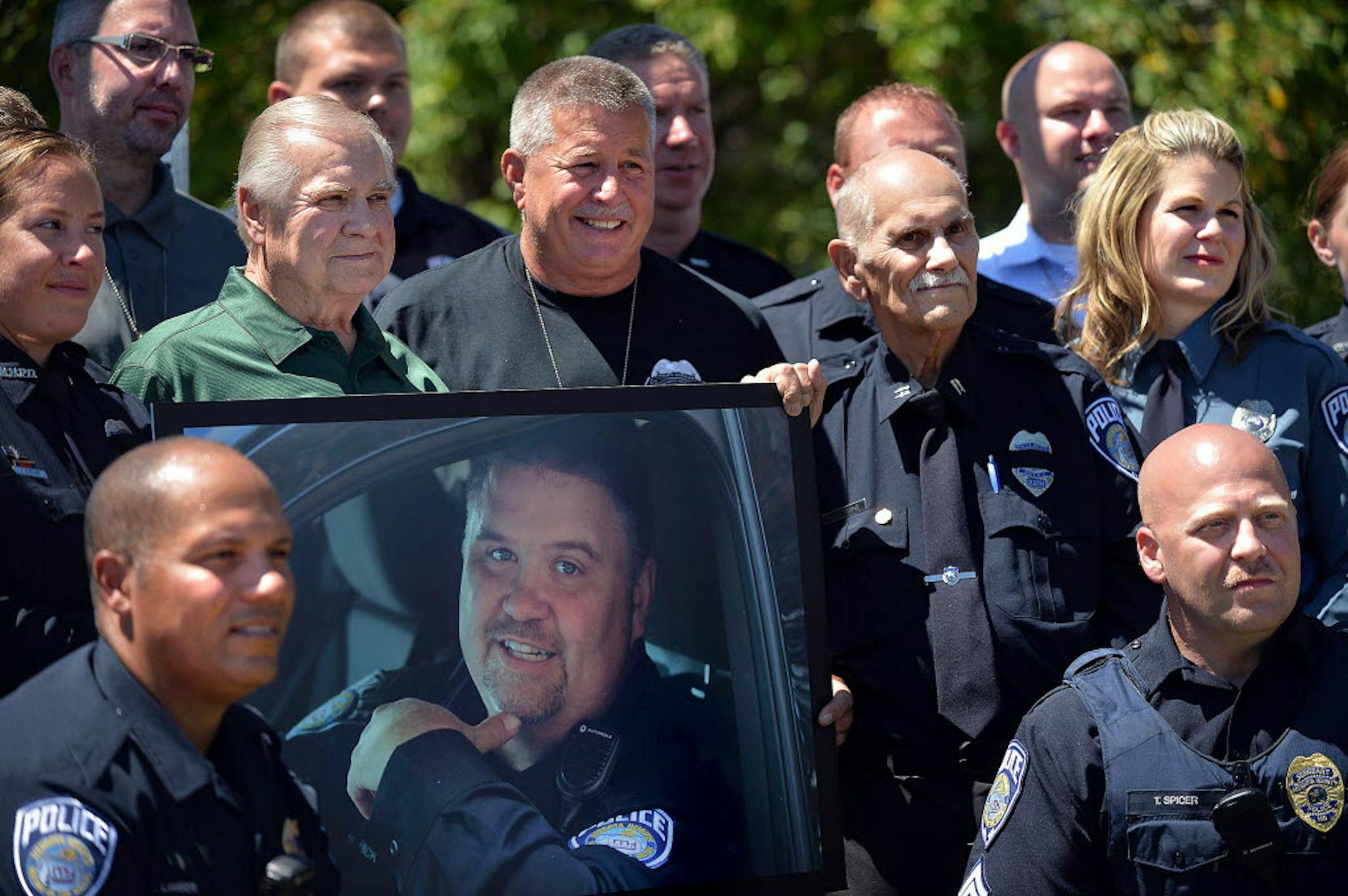 Sgt. Bobby Lambert, lower left, poses with other officers at the unveiling of a sign commemorating fallen Mendota Heights officer Scott Patrick. Photo was taken July 30, 2015, to commemorate the one-year anniversary of Patrick's death.