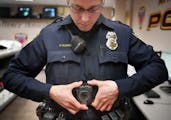 More police departments are using body cameras, including Maplewood, where officer Parker Olding attached his to a magnetic plate inside his uniform.