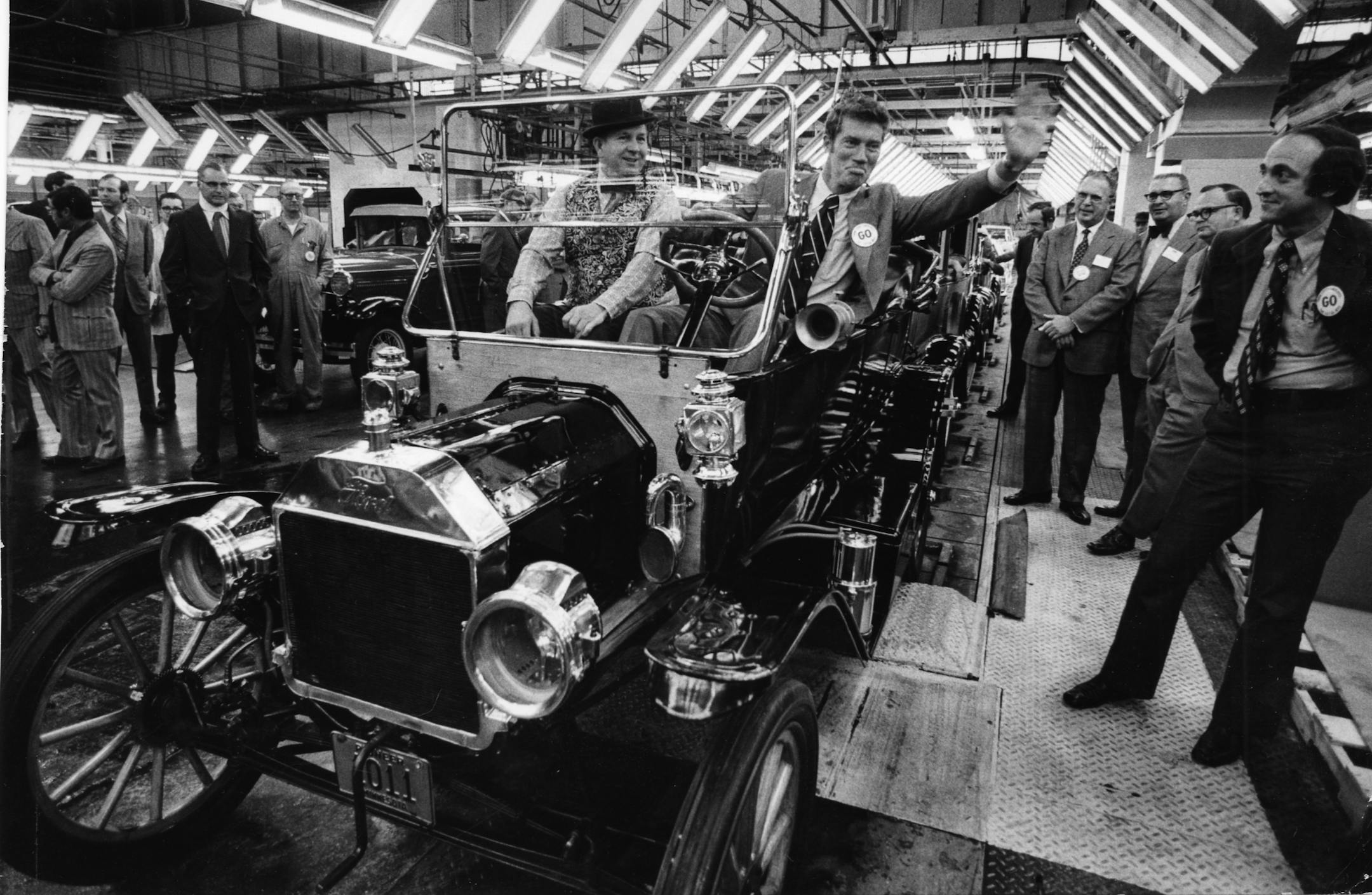 Minnesota Gov. Wendell Anderson waves during a celebration at the Ford plant in St. Paul on the occasion of Ford's 60th anniversary of car production in Minnesota. Anderson is seated in a 1912 Model T; beside him is the car's owner, William Hellms of St. Paul. At right is St. Paul Mayor Lawrence D. Cohen. Minneapolis Tribune (now Star Tribune) staff photo, October 3, 1972, by Donald Black.