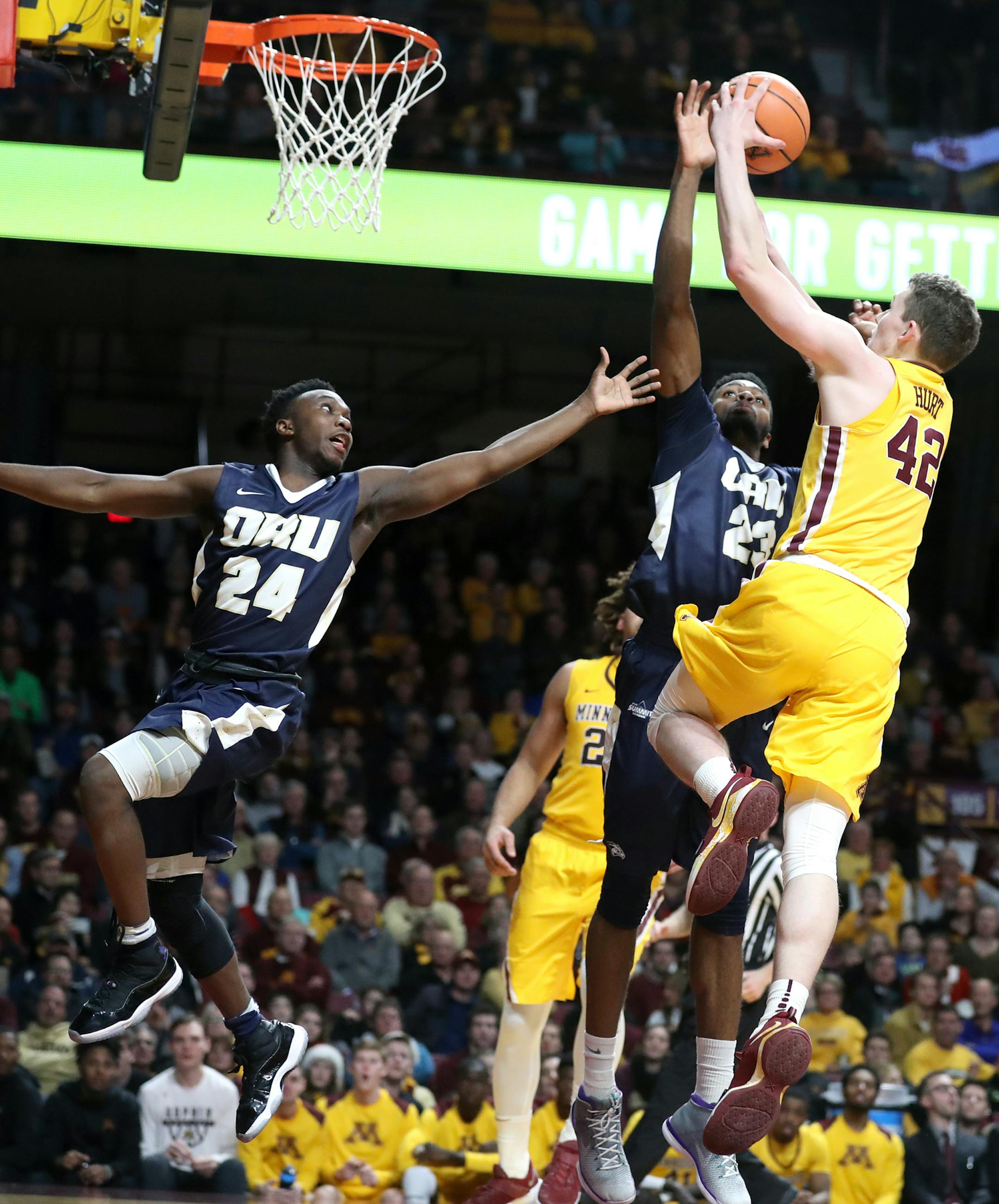 Michael Hurt (42) of the Minnesota Golden Gophers shoots as Emmanuel Nzekwesi (23) of the Oral Roberts Golden Eagles fouls him and R.J. Fuqua (24) of the Oral Roberts Golden Eagles also defends during the second half. ] LEILA NAVIDI ï leila.navidi@startribune.com BACKGROUND INFORMATION: Minnesota Golden Gophers play against the Oral Roberts Golden Eagles at Williams Arena in Minneapolis on Thursday, December 21, 2017. The Minnesota Golden Gophers won 77-63.