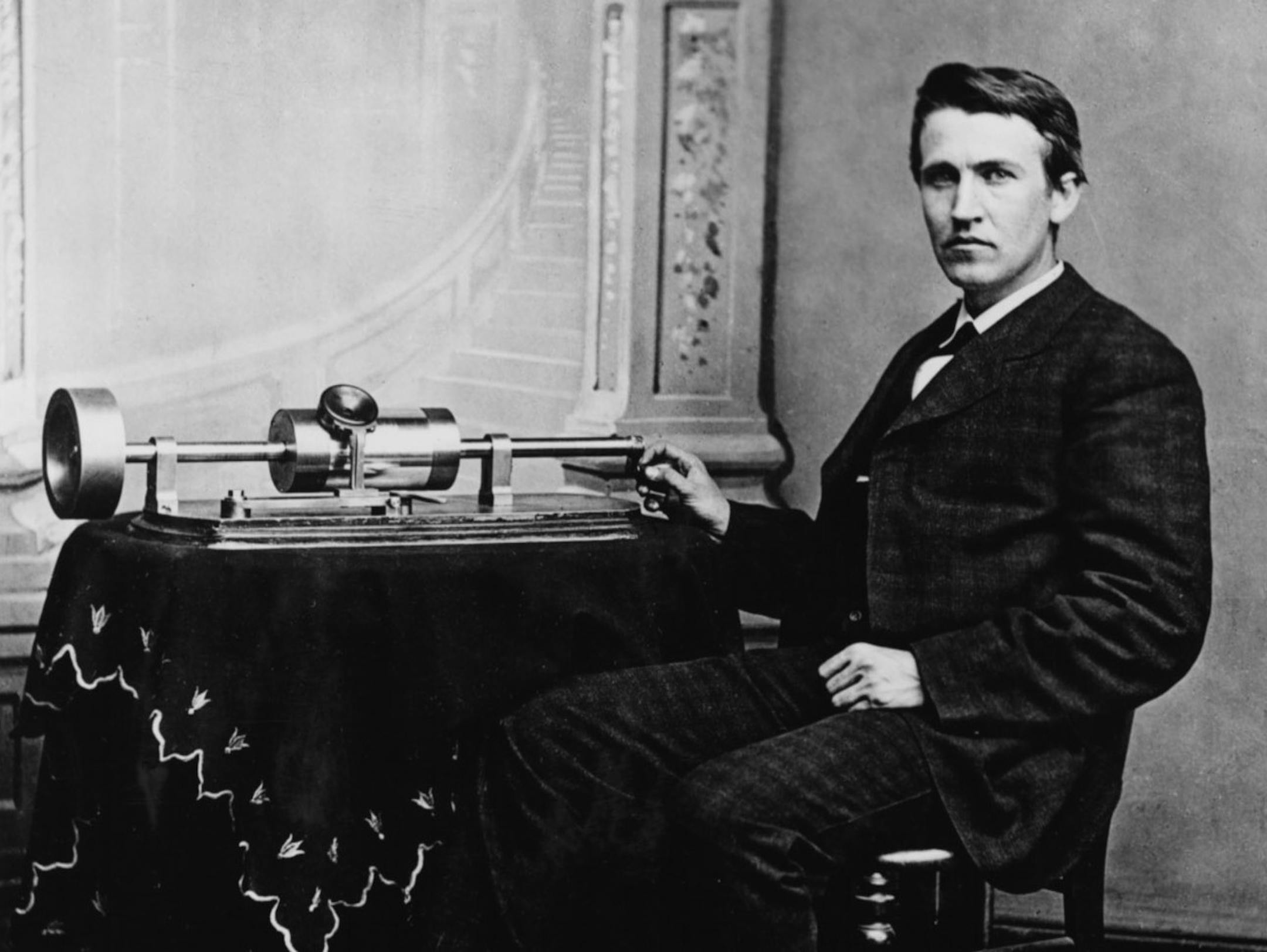 Thomas A. Edison is shown with the tin-foil phonograph of his invention. Historical photo, approx 1877 or 1878.