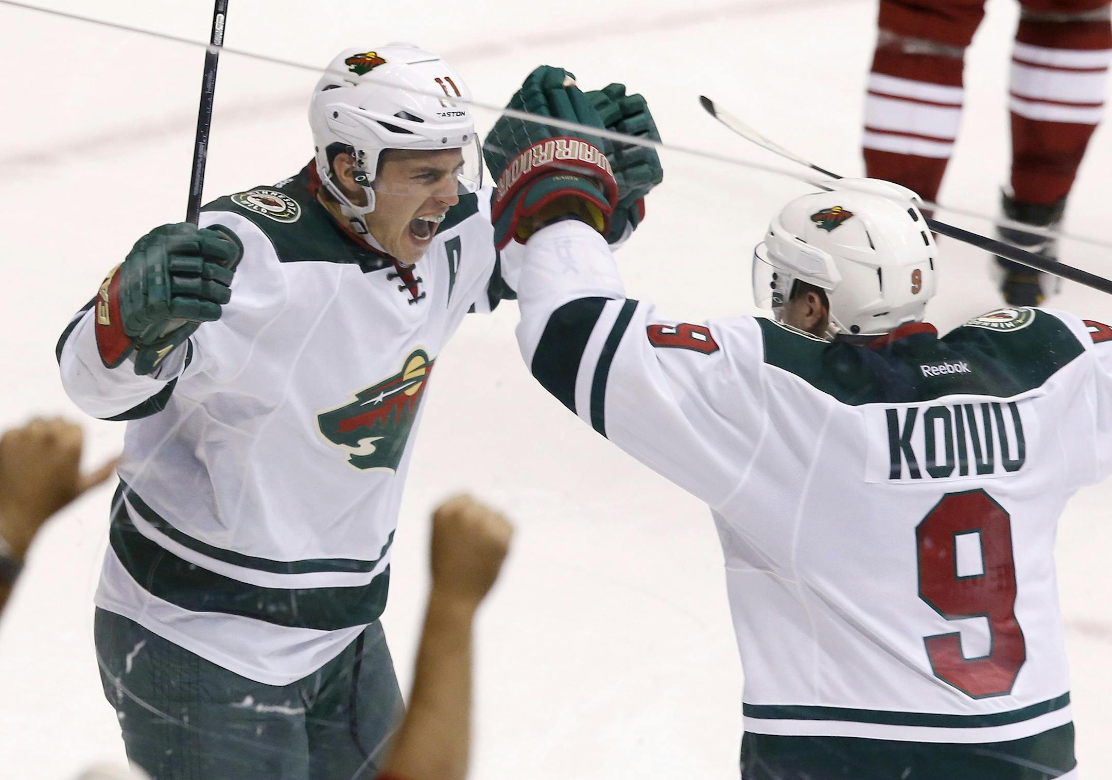 The Wild's Zach Parise (left) celebrated his empty-net goal against the Phoenix Coyotes with teammate Mikko Koivu on Saturday. The Wild defeated the Coyotes 3-1.