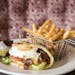 The grilled chicken club with provolone cheese, baby bibb, sliced tomato, maple peppered bacon and an over easy egg on grilled garlic naan at McKinney