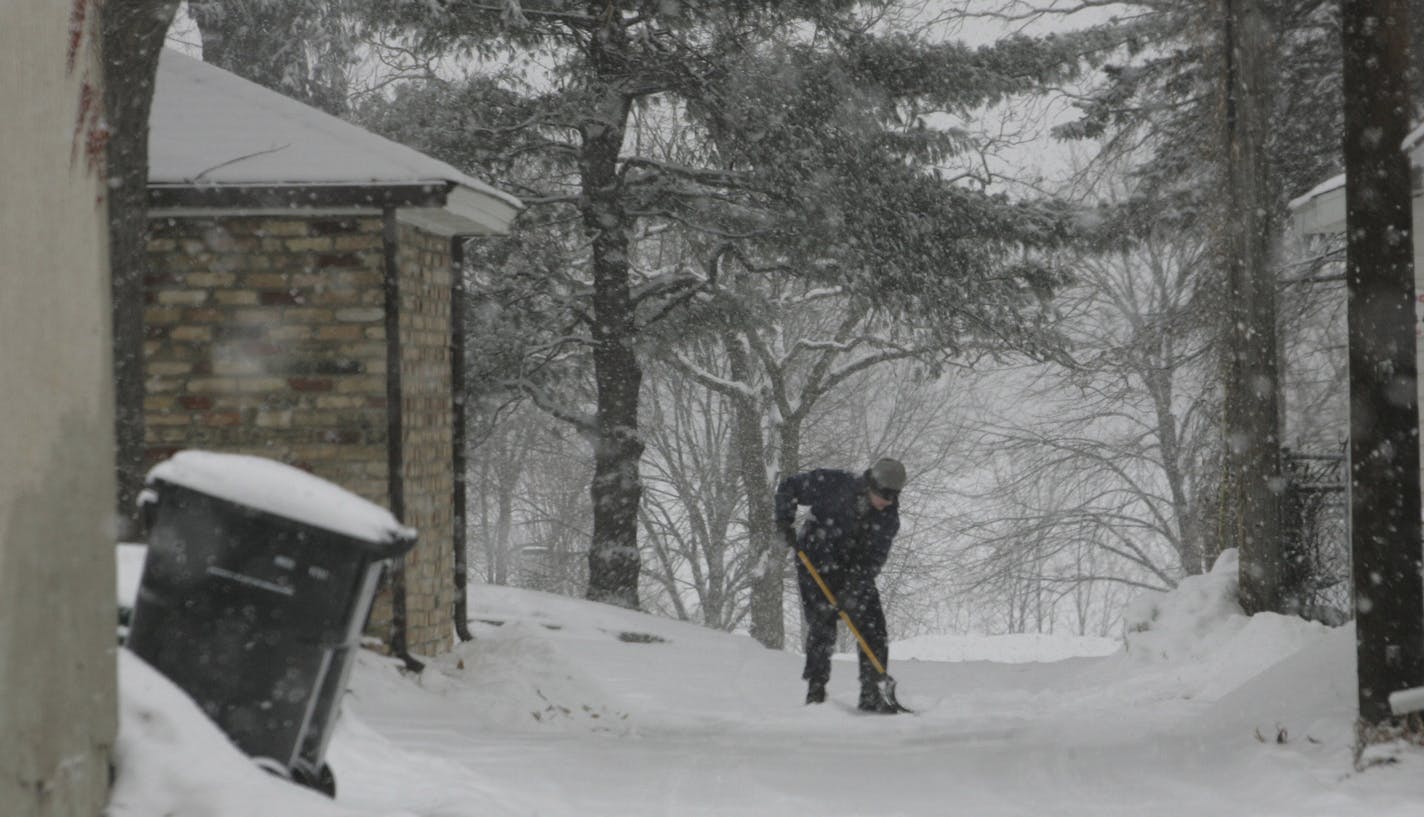 A south Minneapolis resident shovels the snow from her driveway Tuesday, Feb. 6, 2007, in Minneapolis, Minn. Temperatures dropped below zero in Minnesota on Saturday morning, and it was still frigid in northeastern Minnesota early Tuesday, including 31 below zero in Cook, the National Weather Service reported.