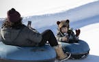 Three-year old Beckett Baack didn't hold back his excitement in going down the tubing hill at Elm Creek Park Reserve with his mother Lexie. The weathe