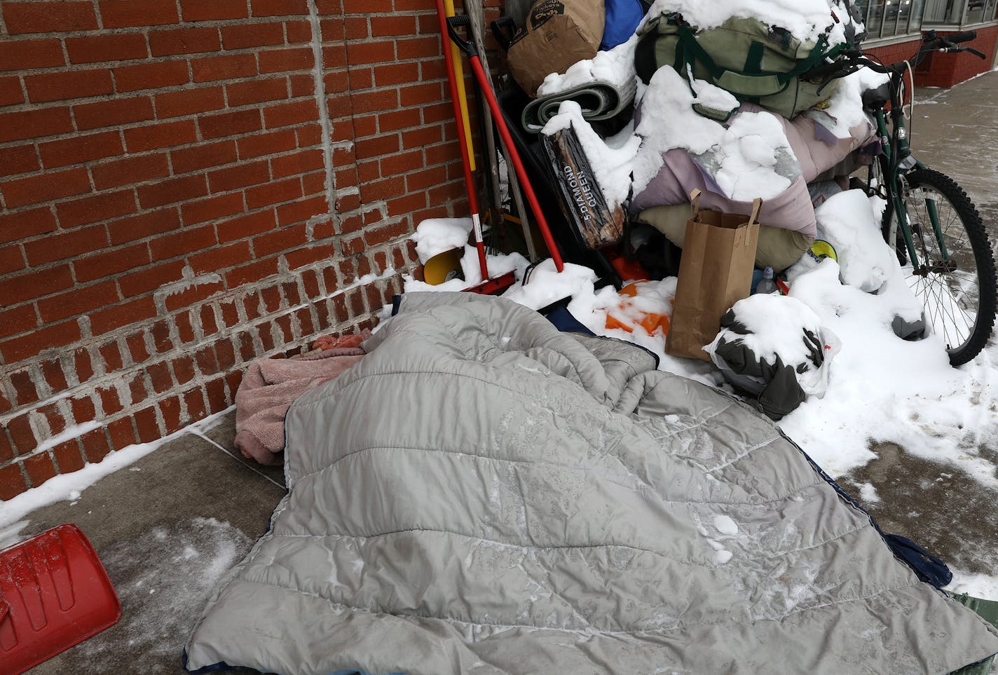 A homeless person slept under a blanket in recent single-digit temperatures. The North End neighborhood is St. Paul&#x2019;s poorest.