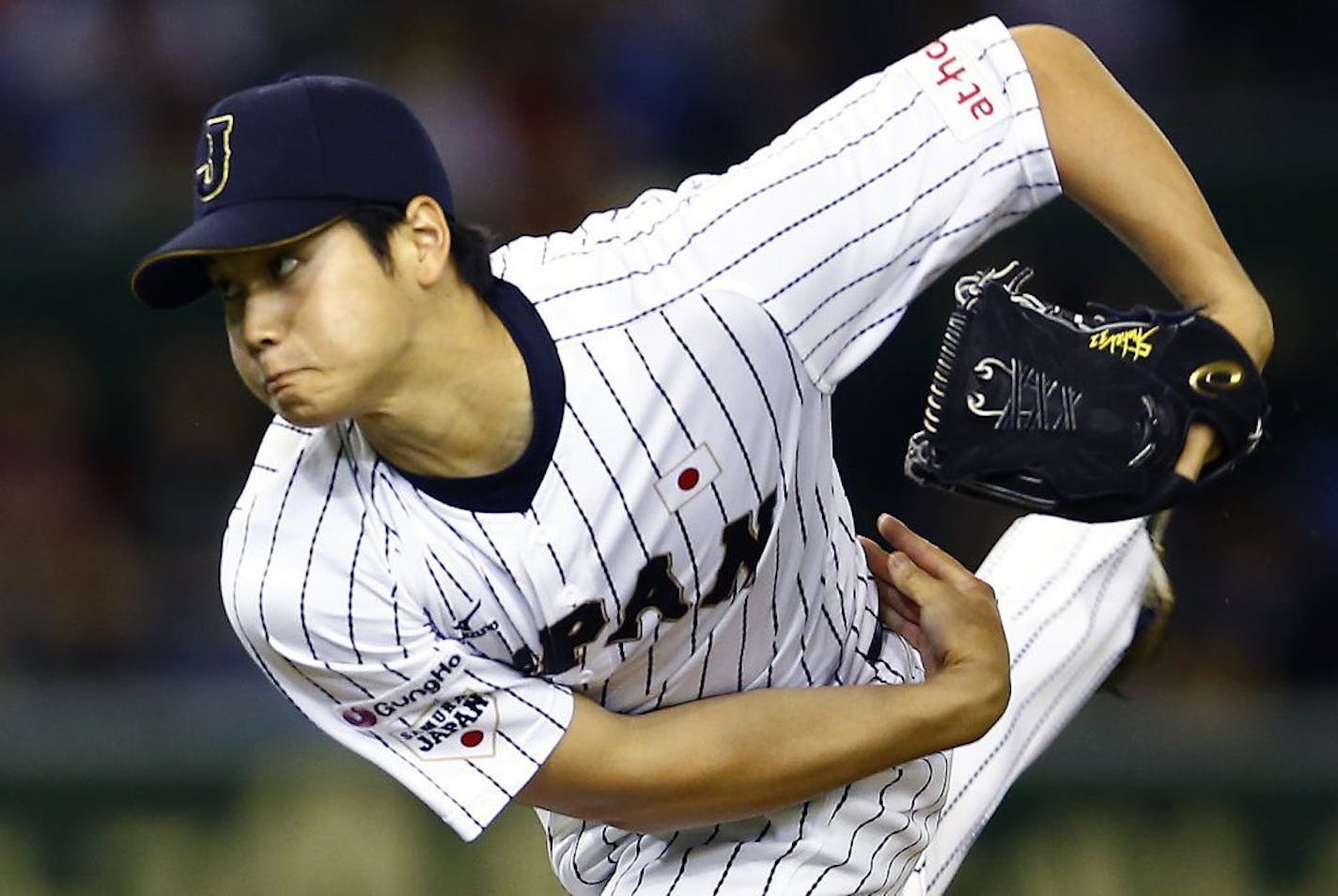 FILE - In this Nov. 19, 2015, file photo, Japan's starter Shohei Ohtani pitches against South Korea during the first inning of their semifinal game at the Premier12 world baseball tournament at Tokyo Dome in Tokyo. A person familiar with the decision says Major League Baseball owners on Friday, Dec. 1, 2017, have approved a new posting agreement with their Japanese counterparts in a move that allows bidding to start for coveted pitcher and outfielder Shohei Ohtani. The person spoke on condition