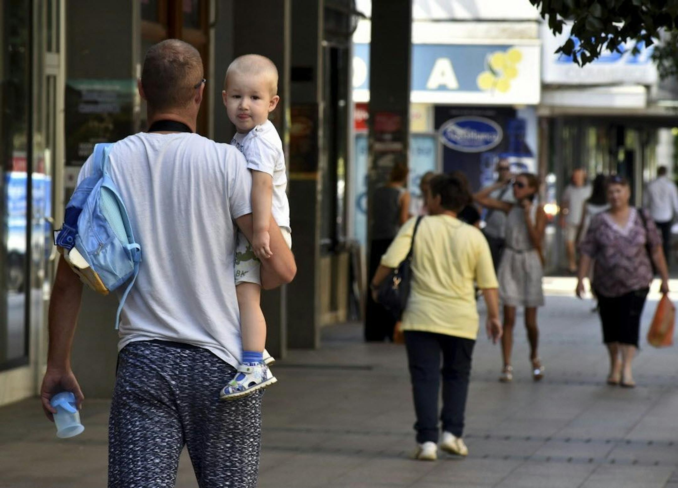 People walk trough the street in Montenegro's capital Podgorica, Thursday, July 19, 2018. U.S. President Donald Trump suggested Montenegro may start World War III, but the government on Thursday issued a statement saying it was proud of the country's "history and tradition and peaceful politics".