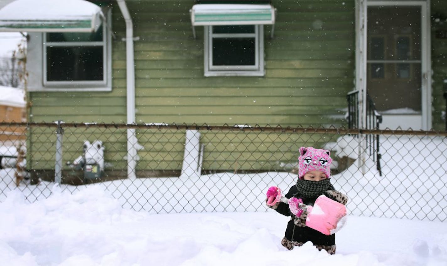 Roselyn Silvestre 2, helped shovel snow in front of her home along Penn Avenue after Saturdays blizzard Sunday April 15, 2018 in Minneapolis, MN. JERRY HOLT • jerry.holt@startribune.com