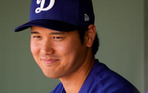 Los Angeles Dodgers designated hitter Shohei Ohtani in the dugout before a spring training game against the Texas Rangers, Wednesday, Feb. 28, 2024, i