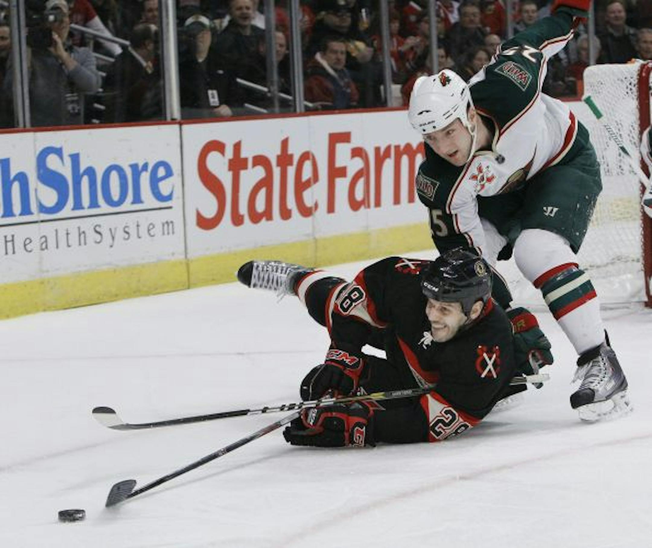 Wild defenseman Cam Barker (right)