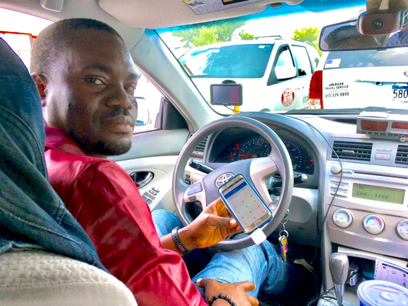 Cowami Di Senard, who drives a cab at the MSP Airport, shows the Square smartphone app that cabbies want to use instead of a device supported by the airport.