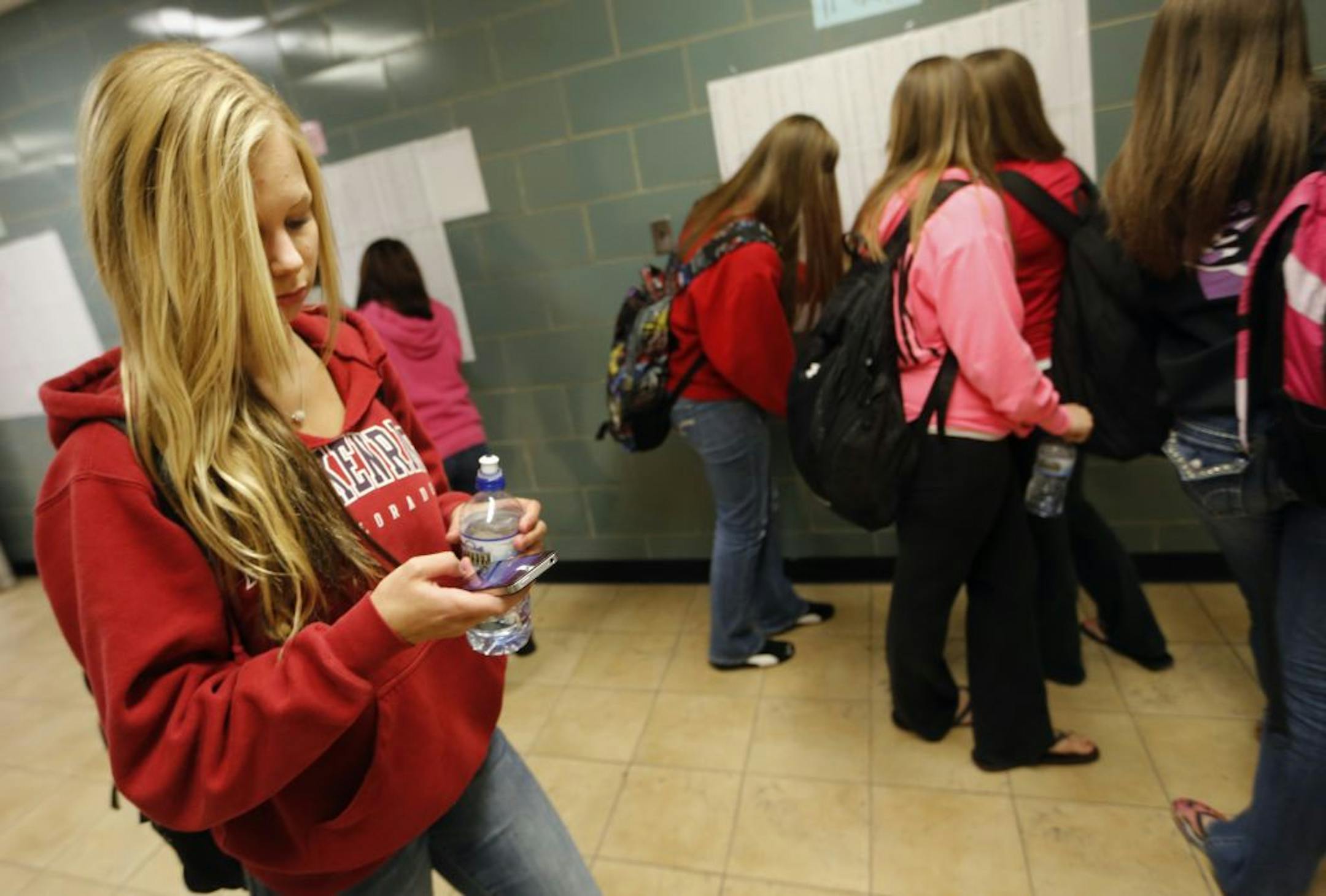 Roseville student Lindsay Feero checked her iPhone on the way to class. Monday's announcement was made at her school.